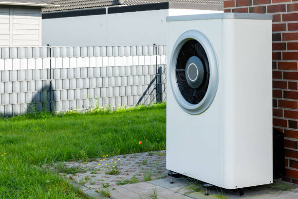 istock Heat pump, sustainable heating solution for modern homes. Environmentally Friendly Heat Pump Technology in Front of a brick house. 2084116159