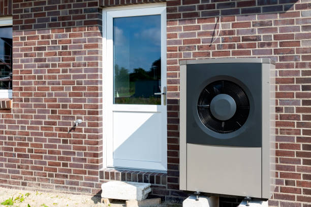 istock Heat pump, sustainable heating solution for modern homes. Environmentally Friendly Heat Pump Technology in Front of a brick house. 2084116675