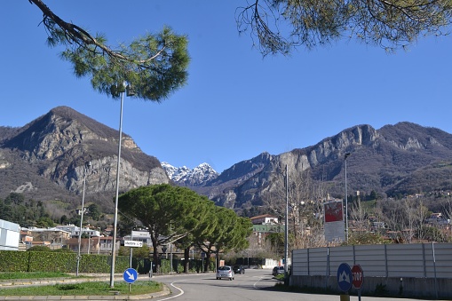 Green street landscape of the town of Calolziocorte under Mount Resegone.