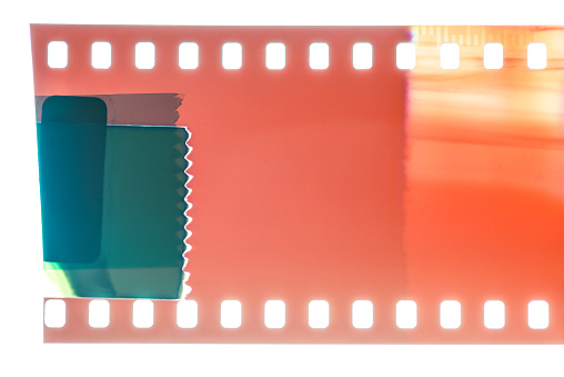 Close up of the end of a 35mm color negative photographic film, with a light-leak close to the end frame.