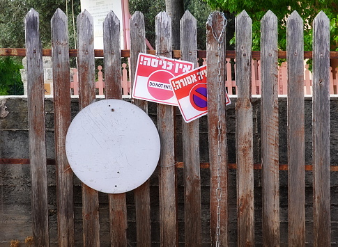 Weathered Wooden Fence with Prohibitive Signs