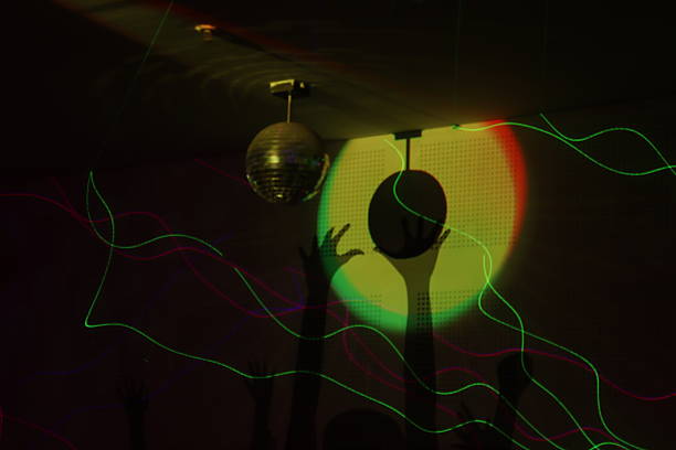 Colorful circles of light are overlapping, creating a vibrant and festive bokeh effect against a dark background, perfect for adding a touch of magic to any project