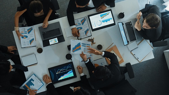 Time lapse of diverse marketing team prepare for business meeting. Top down aerial view of businesspeople placed laptop and tablet with financial statistic at table. Creative business. Directorate.