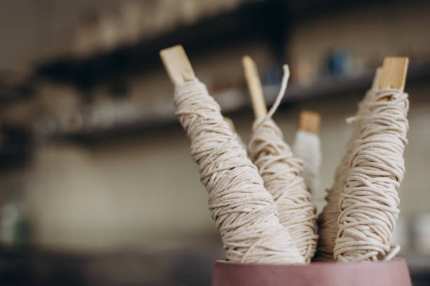 istock Woman making aromatic candles at wooden table, closeup 2084159403