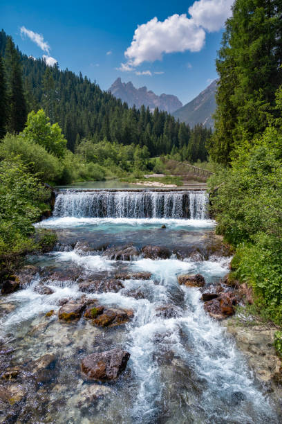 istock Beautiful waterfall with flowing water in the middle of a forest 2084161231