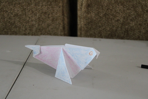 Homemade origami pigeon on table
