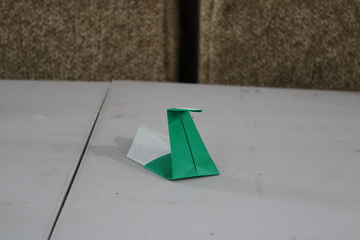Homemade origami crane on table