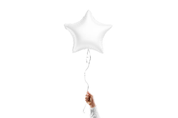 istock Hand holding blank white star balloon mockup, isolated 2084161696