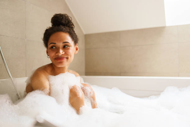 istock a woman is taking a bath in a bathtub filled with foam 2084161756