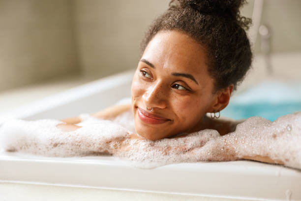 istock Woman smiling in bathtub, enjoying a leisurely bath and feeling comfortable 2084163344