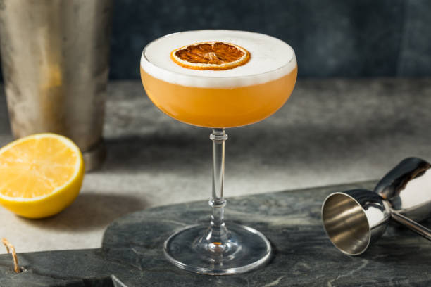 Boozy Cold Frothy Whiskey Sour Cocktail Boozy Cold Frothy Whiskey Sour Cocktail with Bourbon and Eggwhite sour taste stock pictures, royalty-free photos & images