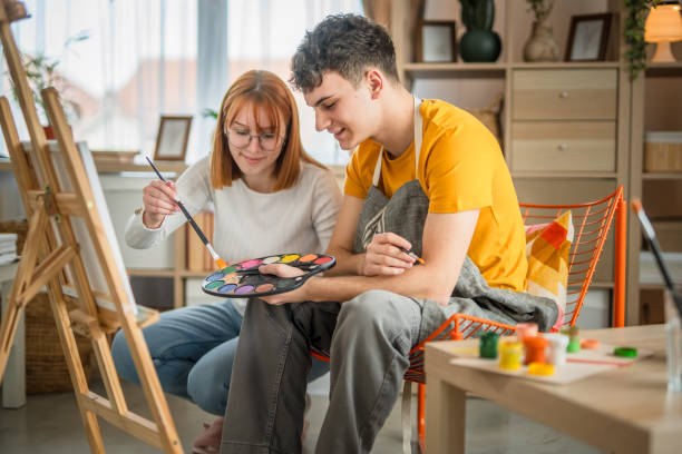 istock Two students are painting on canvas at home 2084217591