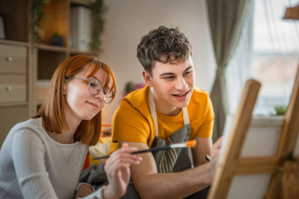 istock Two students are painting on canvas at home 2084218646