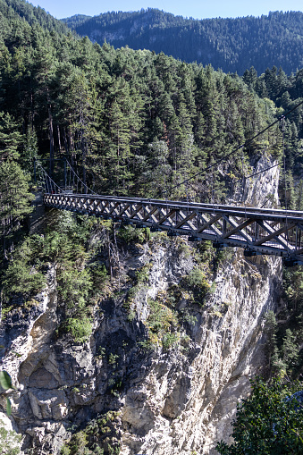 Summer view of the Devils bridge (Pont du diable) above the Arc Gorge in the French alps. This travel destination is situated near Modane in the Vanois National Park of Savoie in France.