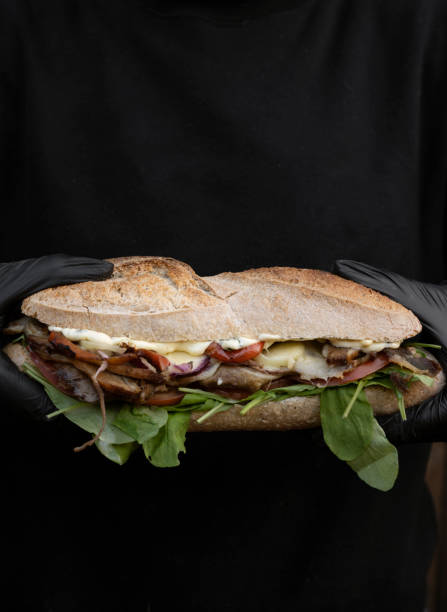 istock Chef holding a gourmet meat sandwich 2084236389