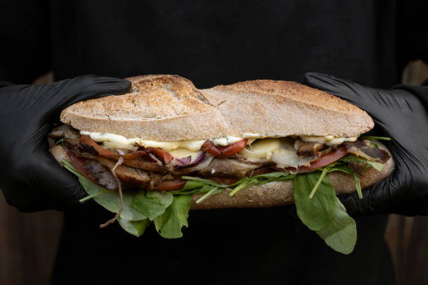 istock Chef holding a gourmet meat sandwich 2084236907