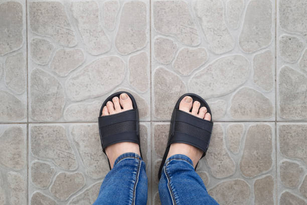 Selfie from personal perspective. View from above on feet in pool flip-flops.