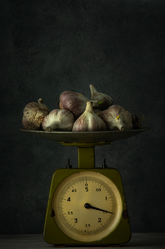 Garlic on the scales. Still life.