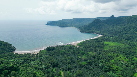 A green beach and ocean in Praia Grande, Sao Tome, South Africa,