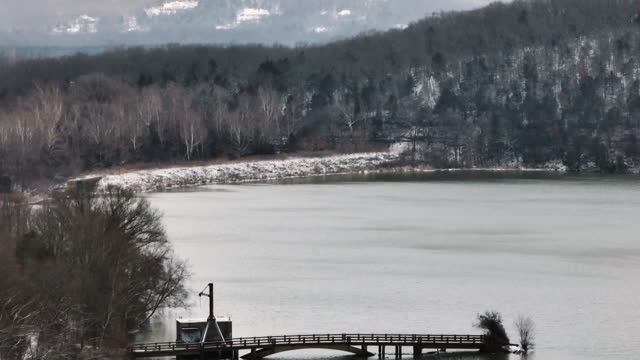 Fishing Pier On Lake Sequoyah In Winter. Fayetteville, Arkansas, USA. drone tilt-up shot