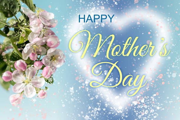 Glowing heart shape with HAPPY MOTHER'S DAY lettering, apple blossom and lots of glittering particles. Can be used as a design for Mother's day holiday greeting cards or posters.