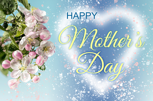 Glowing heart shape with HAPPY MOTHER'S DAY lettering, apple blossom and lots of glittering particles. Can be used as a design for Mother's day holiday greeting cards or posters.