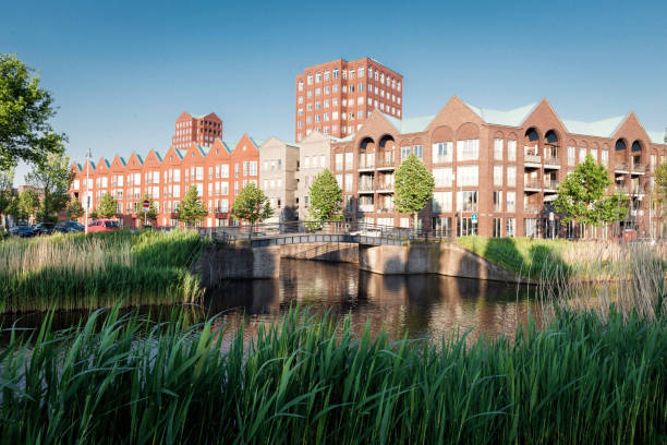 Amersfoort Vathorst city view at blue sky.Vathorst is a Vinex location of the city of Amersfoort in the Dutch province of Utrecht. Construction of 11,000 homes started here in 2001. The district is located north of Amersfoort on the territory of the former municipality of Hoogland. The territory of the municipality of Amersfoort has also been expanded for the district at the expense of Nijkerk and the former municipality of Hoevelaken. The district surrounds the entire area around the village of Hooglanderveen. Vathorst is named after the farm Vathorst, where the meaning of \
