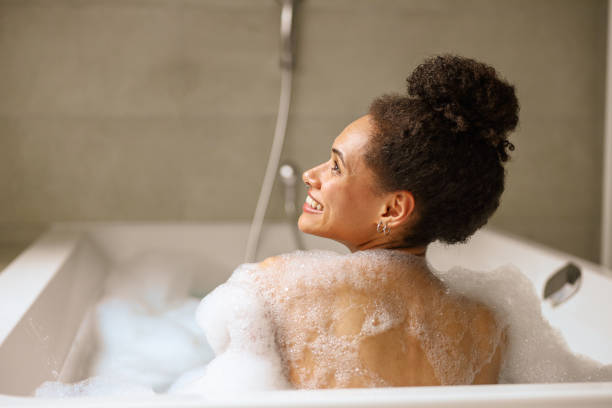 istock a woman is taking a bath in a bathtub filled with foam 2084277130