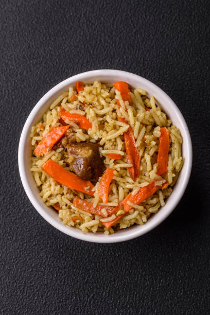 istock Delicious pilaf with vegetables, salt, spices and herbs in a ceramic plate 2084281448