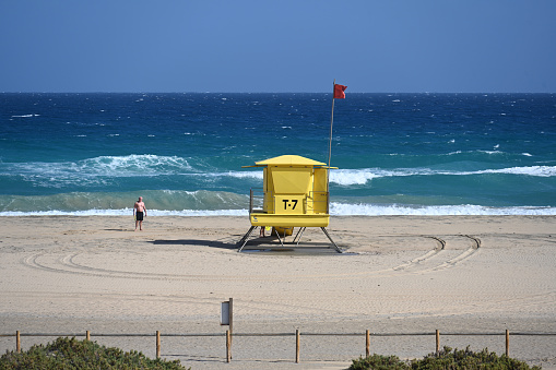 Morro Jable, Fuerteventura, Canary Islands, Spain, February 28, 2024 - Lifeguard tower on the stormy beach of Jandia / Matorral Beach, Fuerteventura, Spain.