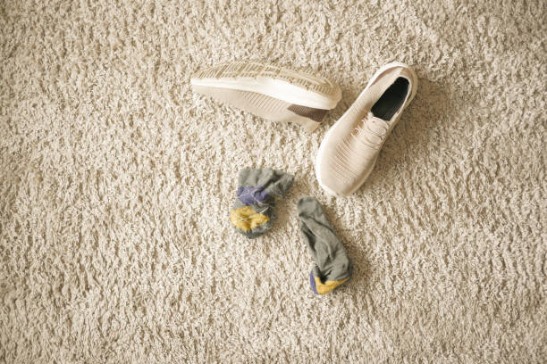 istock dirty sock and shoe on floor 2084294091