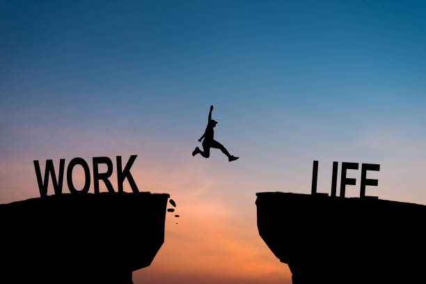 istock Woman jump through the gap between Work to Life on sunset. 2084310399