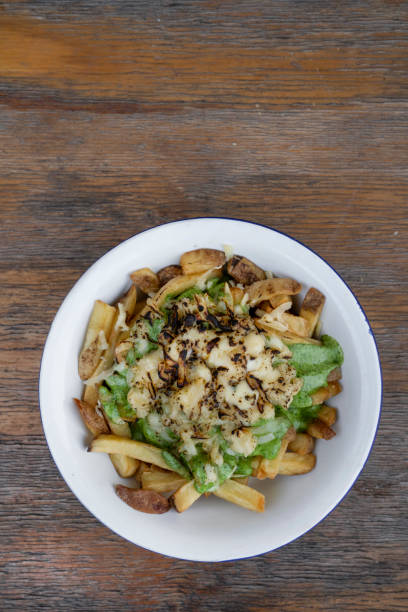 istock Gourmet fried potatoes with a rustic wooden background 2084351072