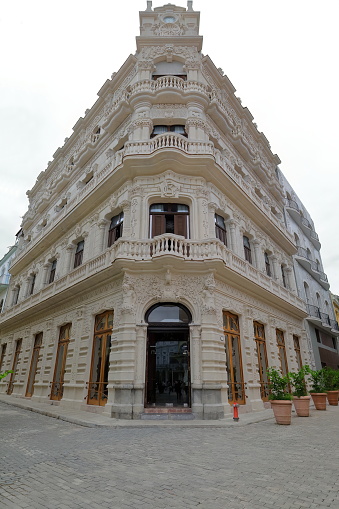 Art-Nouveau building at Mercaderes and Muralla Streets southeast corner, Plaza Vieja-Old Square, with carved stonework of griffins, satyrs and wave-shaped balconies over Telamons columns. Havana-Cuba.