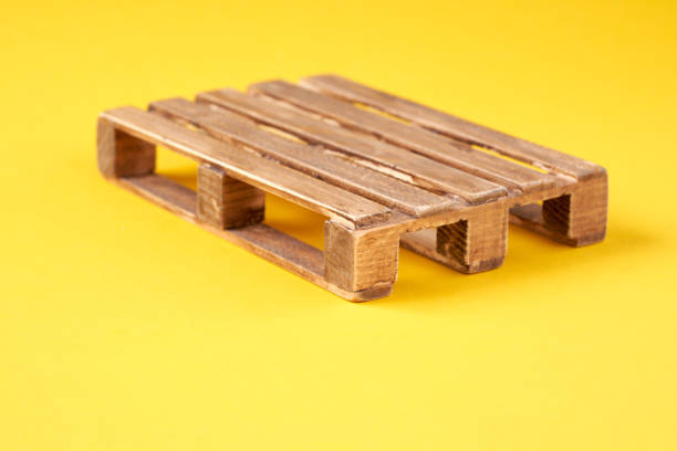istock A wooden transport pallet on a yellow background. 2084352656