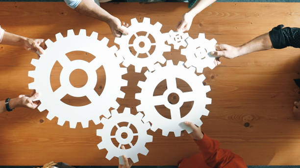 istock Top view of business people gathering white gear together at table. Convocation. 2084366834