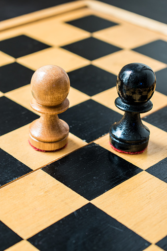 Close up of wooden chess pieces on wooden board