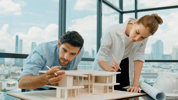istock Cooperative engineer team working together to measure house model. Tracery 2084395933
