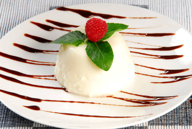 Rice pudding. Rice pudding dessert garnished with raspberry on a plate with lines of liquid chocolate