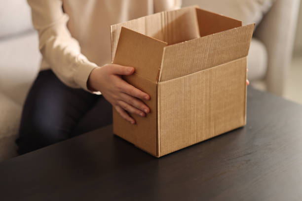 istock Young Woman Unboxing A Package 2084419006