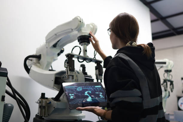 istock A female mechatronics engineer is working with a robotic arm prototype to examine new programming in the quality room at a manufacturing  welding  factory 2084424941