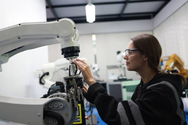 istock A female mechatronics engineer is working with a robotic arm prototype to examine new programming in the quality room at a manufacturing  welding  factory 2084424945