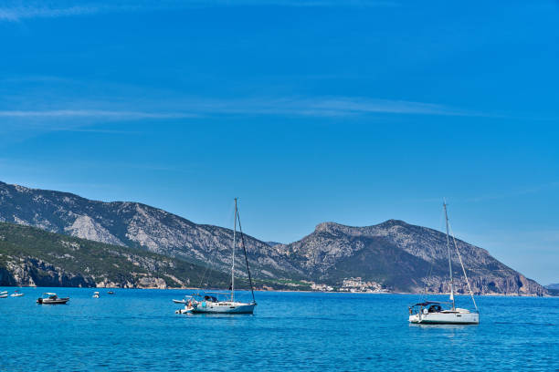 Boats in Porto Pollo bay on the sunset light, Gulf of Valinco, Corsica, France
