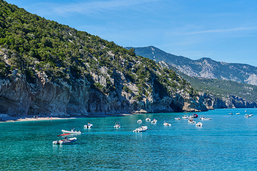 Dorgali, Italy - October 6, 2022: rubber Boats moored in Cala Luna, a famous tourist destination in eastern Sardinia.