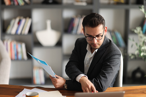 Young handsome businessman working in office.