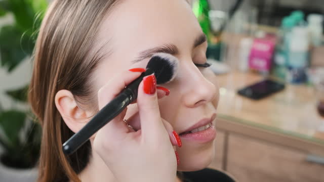 Young lady comes to beauty salon to do professional makeup