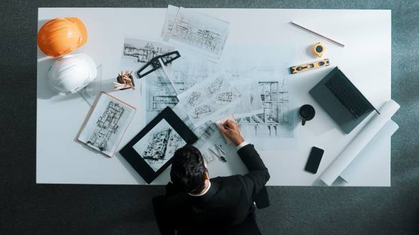 istock Top view of skilled engineer selecting material for house design. Alimentation. 2084475885
