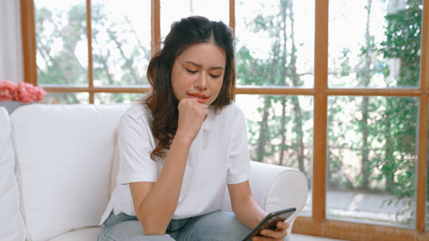 istock Young woman using smartphone browsing for online shopping E commerce by online payment gateway at vivancy home. Modern and convenience online purchasing make secure and convenient purchases. 2084484408
