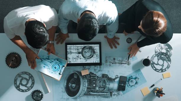 Top view of engineer working together while looking at jet engine. Alimentation.