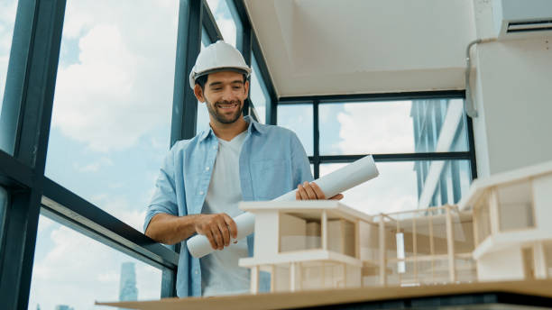 istock Civil engineer standing, walking while looking at house model. Tracery 2084494981
